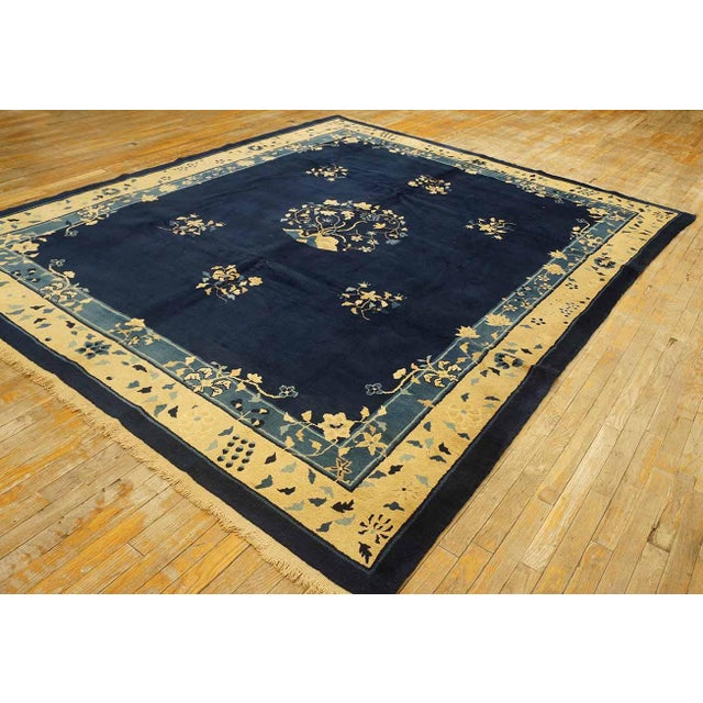 Antique Peking Chinese Floral, Medallion Navy 1900s Rug, Circa Date: 1900s. This exceptional example of a Peking weaving...