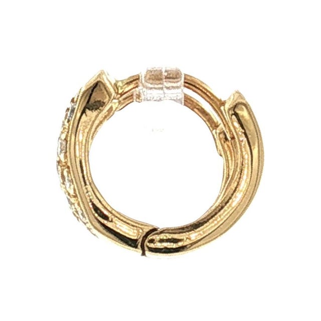 A pair of late 20th-century 18k yellow gold hugger-style earrings featuring pave-set brilliant-cut white diamonds. The...
