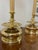 A pair of Chapman attributed brass candlestick lamps with spherical cast brass bases, tall columns, original black...