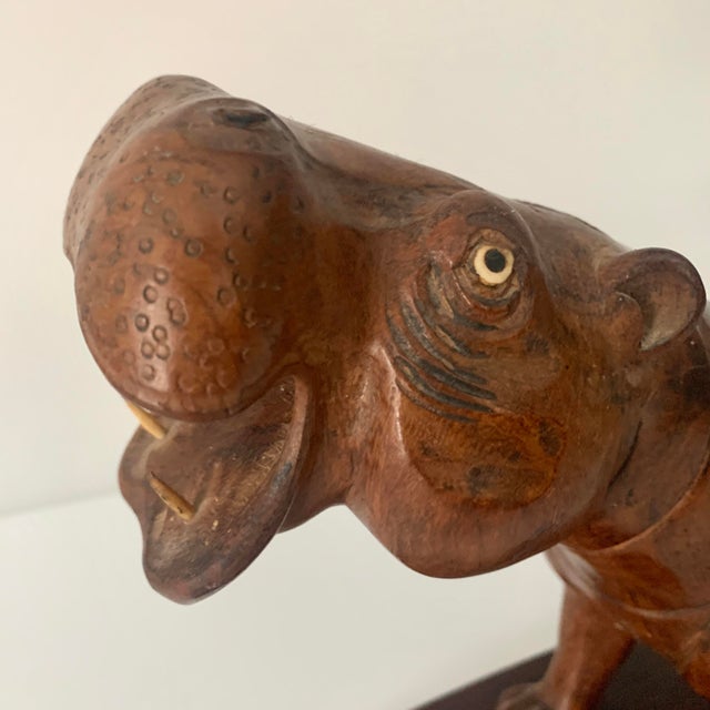 This is an expertly done wood carving with the grain of the wood placed perfectly and with so much expression in the face....