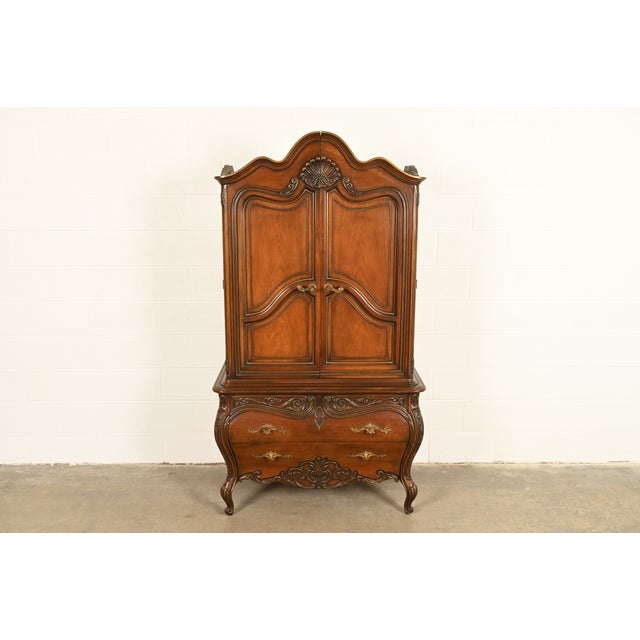 A gorgeous French Rococo Louis XV or French Provincial style armoire dresser By Romweber USA, Circa 1960s Beautiful carved...