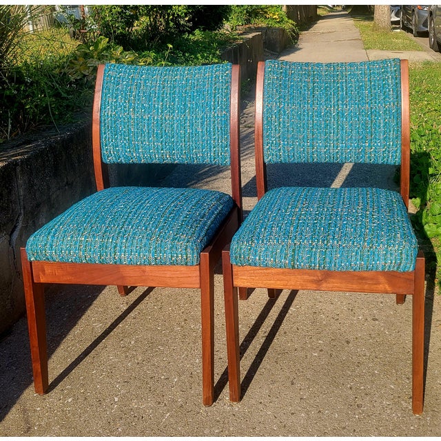 The elegant walnut mid-century frames of these side chairs from Taylor Chair Co. are nicely complimented by the original...