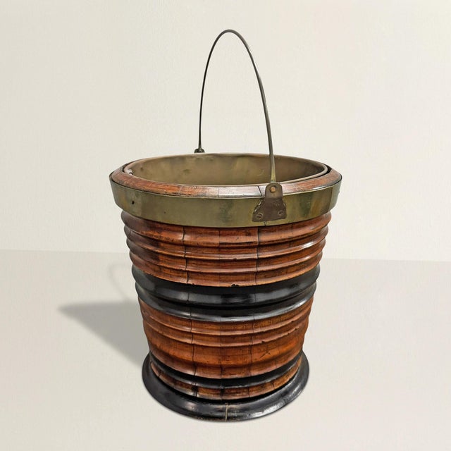 This early 19th-century George III peat bucket transforms a once-humble task into something unmistakably composed. Crafted...