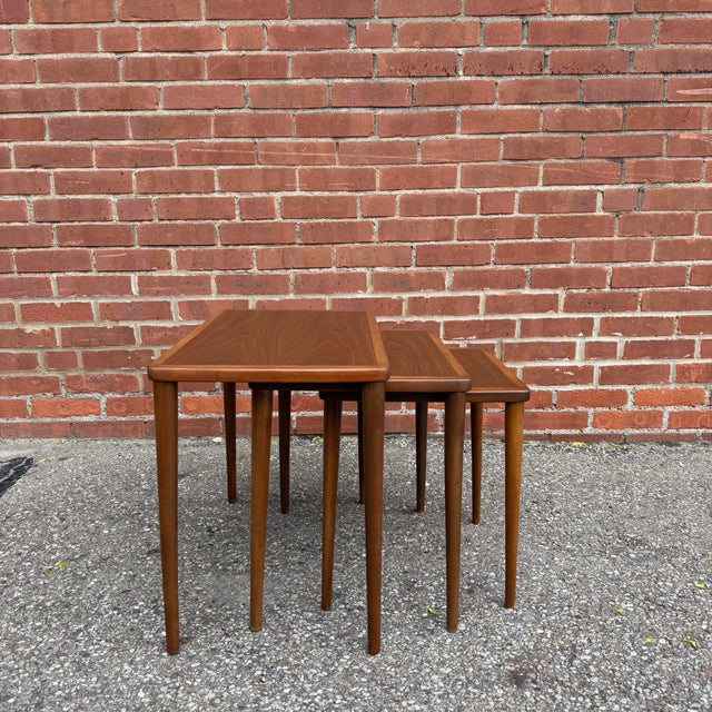 Clean, well-proportioned nesting tables with softly rounded edges, tapered legs, and beautifully matched teak grain...