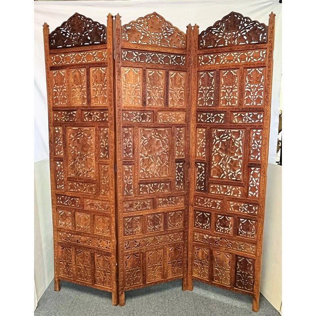 Awesome vintage Moroccan style three panel floor screen from the 1960's. Made of a natural medium tone wood with pierced...