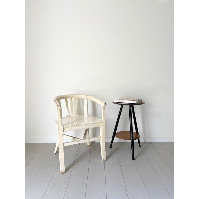An antique side table in an ebonised finish with turned tripod legs and chunky button feet. This stylish occasional table...