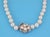 Pure perfection and elegance describes this stunning Estate single strand pearl necklace. The lovely floral clasp is...