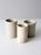 Set of three antique stoneware crocks in softly varied cream and off-white glazes. Each crock has its own subtle...