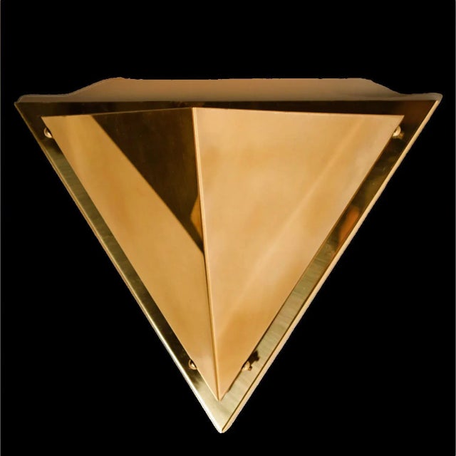 One of the five pyramid shaped brass wall lamps, 1970. Each wall light consist brass shades, which are held with brass...