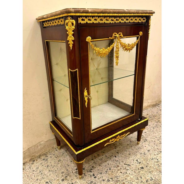 This elegant Louis XV-style marquetry bedside cabinet showcases refined French craftsmanship with a sophisticated blend of...