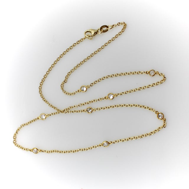 Eight Old European Cut diamonds, in their originally antique bezels settings, are suspended from a 14k gold chain, spaced...