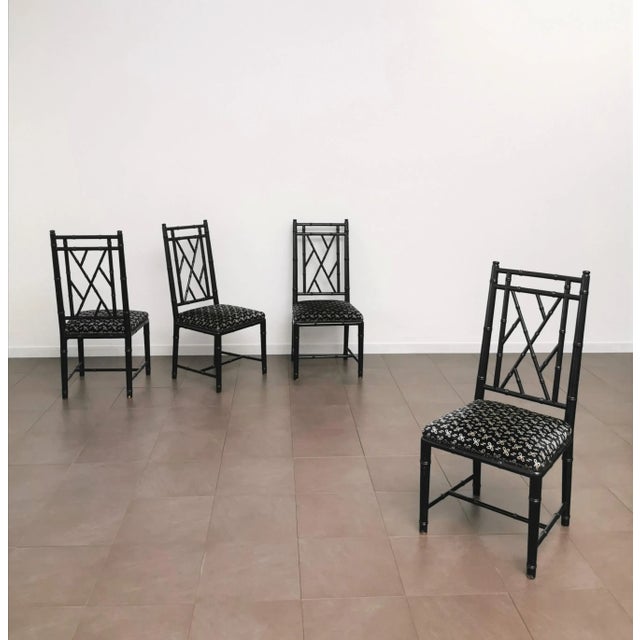 Elegant and fine set of 4 chairs produced in Italy in the 80s. Each single chair was made of black enameled wooden...