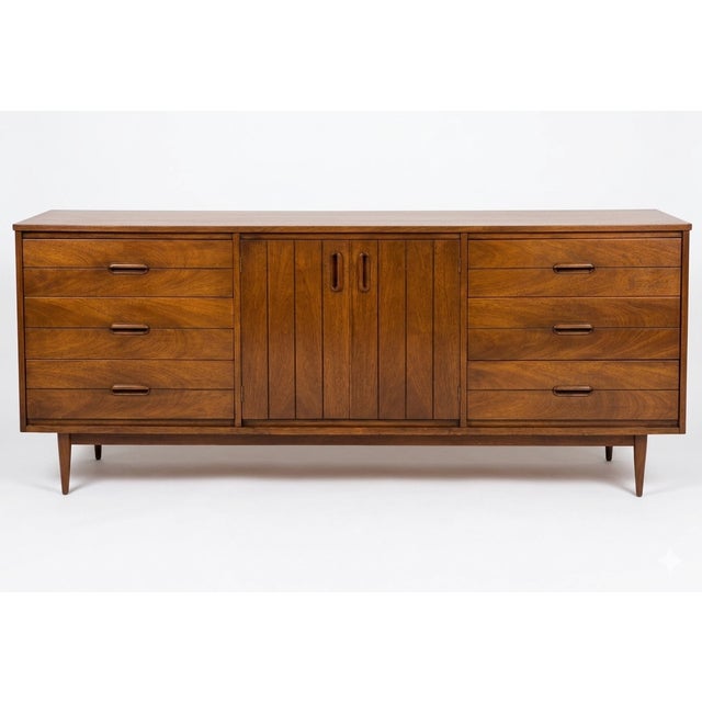 This stunning Mid-Century Modern walnut triple dresser by Basic-Witz perfectly balances iconic 1960s style with incredible...