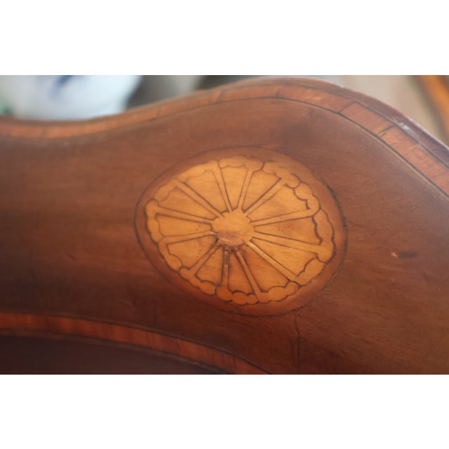A rare and beautifully detailed Edwardian Sheraton Revival corner chair, crafted in richly toned mahogany circa 1900–1910....