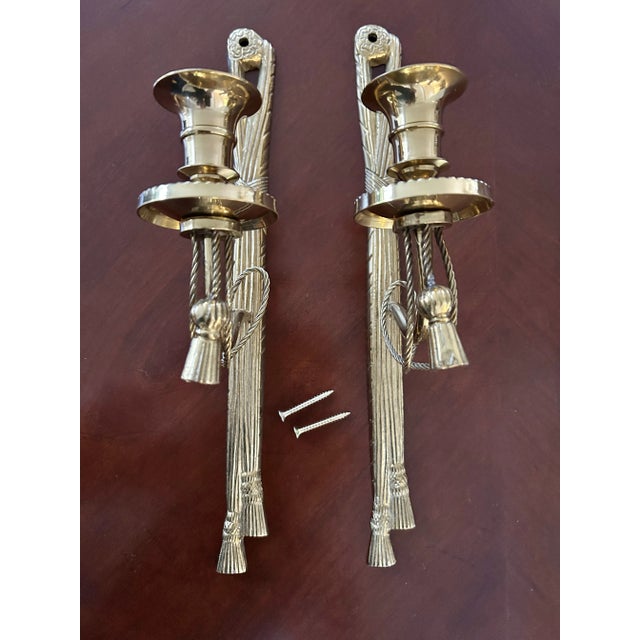 This pair of candle wall sconces has all of the features… solid brass, reed and ribbon detail, tassels … perfect! At the...