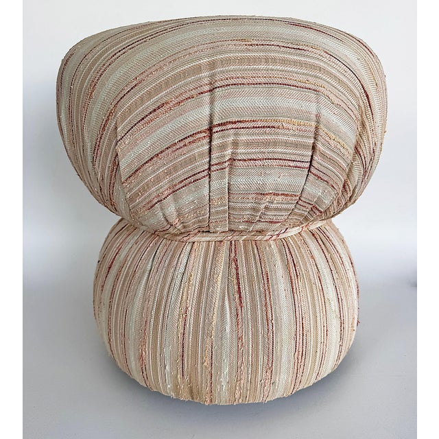 Vintage Boho Upholstered and Cinched Pouf on Casters Offered for sale is a vintage pouf on casters that is upholstered in...