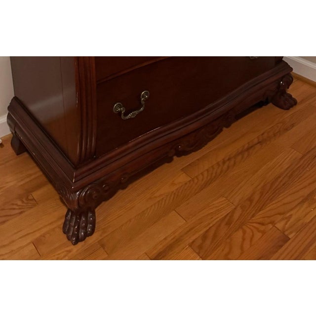 Traditional tall chest of five drawers in the Chippendale revival taste, with a serpentine front, reeded corner columns,...