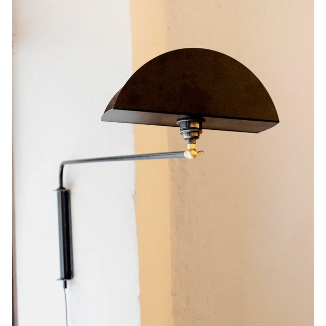 This wall light features a black lacquered arm with an adjustable shade. The arm also moves from left to right. E27 bulb...