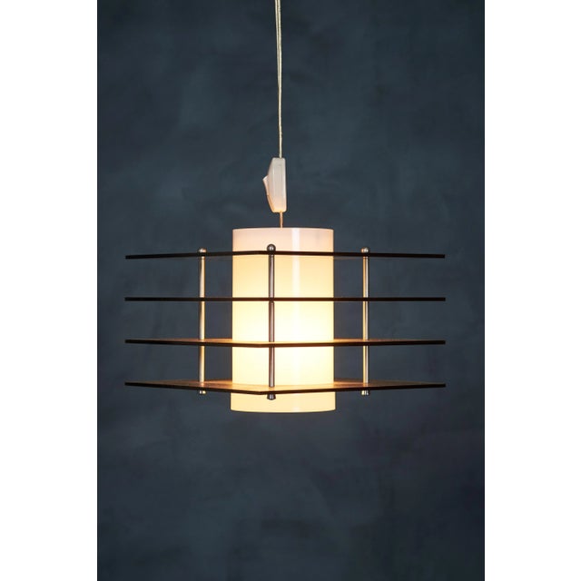 Beautiful pendant lamp with a white inner shade in plastic and four grey square acrylic slats. Made in Denmark in the 70s...