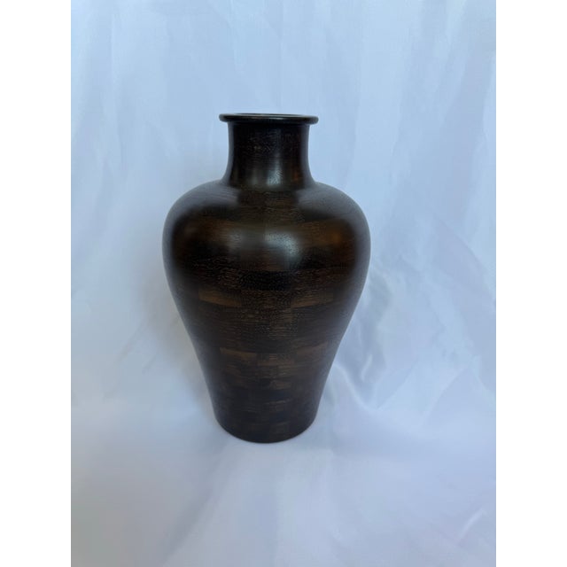 "Korea" was inspired by a vase the artist purchased while in Korea. This custom Walnut piece was made using a segmented...