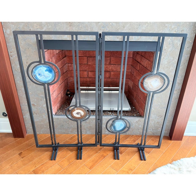 Striking vintage folding fireplace screen crafted from matte black iron with four polished natural agate stone insets in...