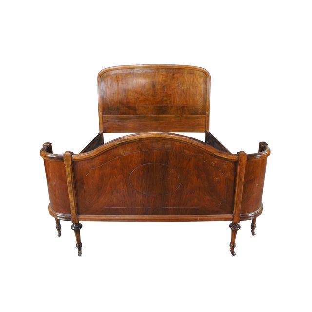 Antique French full size bed frame crafted from burled walnut, featuring a curved headboard and footboard with tapered...