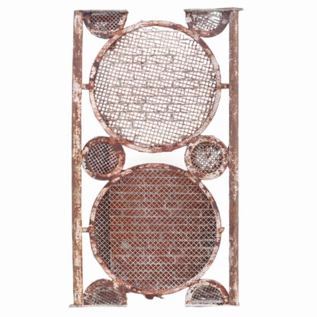 A striking pair of large iron panels featuring a bold repeating circle motif, dating to around 1940. Likely used as...