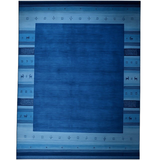 A hand-loomed wool rug, made in India and measuring 4' x 6'. Geometric drawing - repeating motifs held inside strong...