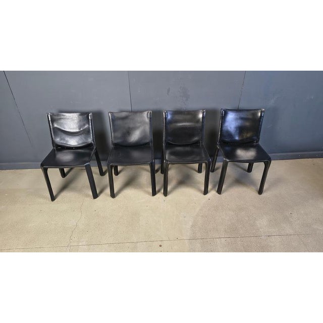 Set of 4 vintage black leather cab chairs designed by Mario Bellini for Cassina These timeless chairs are made of the best...