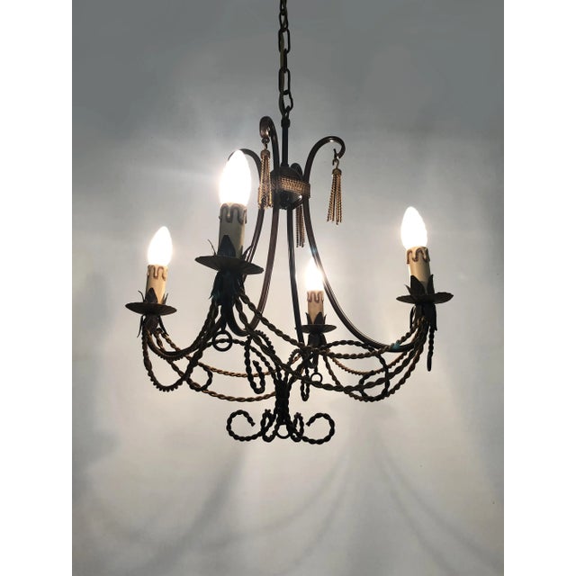 Vintage 4-light chandelier from the 1980s. Brown and gold metal. This 4-light chandelier from the 1980s, inspired by early...