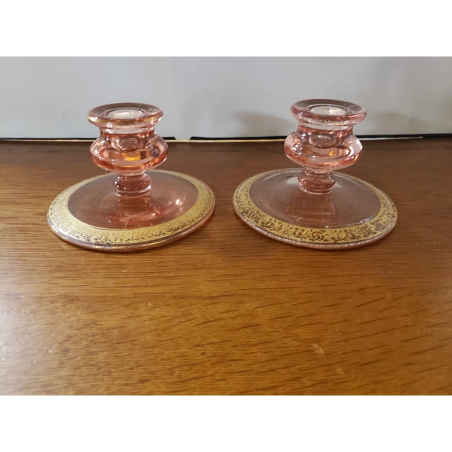 This is a Pair of Vintage Pink Depression Glass Tapered Candle Holders Gilded Floral Scroll Design. They each measure 3"...