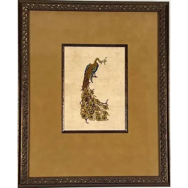 Beautiful vintage cross-stitch embroidery of right-facing male peacock. The lowered tail feathers swirl like the train of...