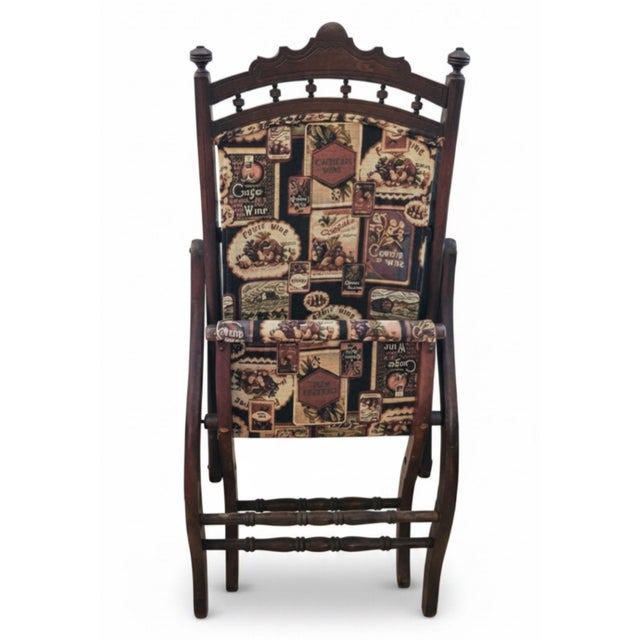 A distinctive late 19th-century Victorian folding parlor chair featuring an unusually decorative carved wood frame and...