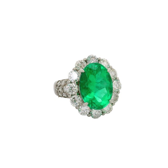A striking and elegant ring featuring a fine 4.32 carat oval- emerald. It boasts a vivid green color that captivates the...