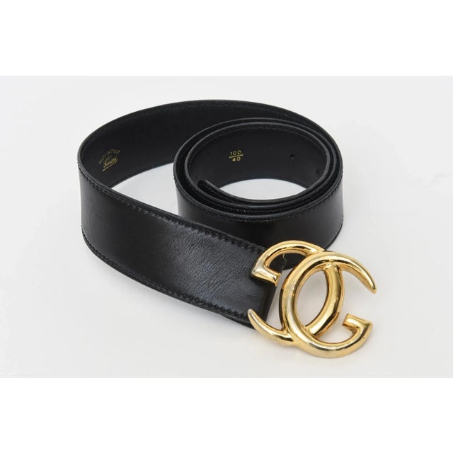 This 1980's Gucci black leather logo wide vintage belt is Italian and has the large gold plated GG's. It says 100/40 on...
