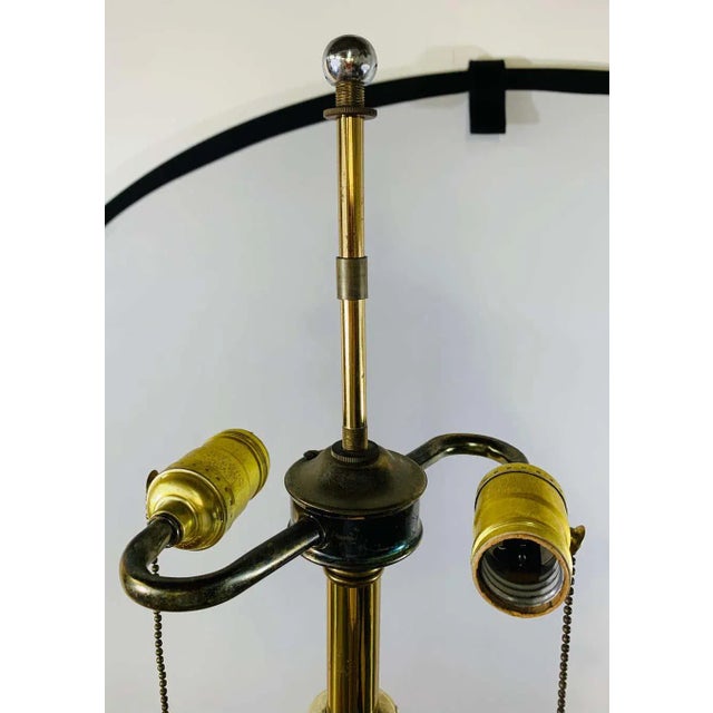 An elegant pair of Mid-Century Modern brass and chrome table lamps in the style of Tommi Parzinger. Made in faux bamboo...