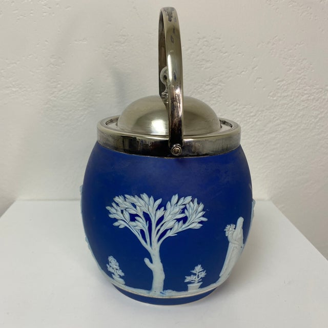 A stunning example of 19th-century British design, this antique Wedgwood biscuit barrel features rich cobalt blue...