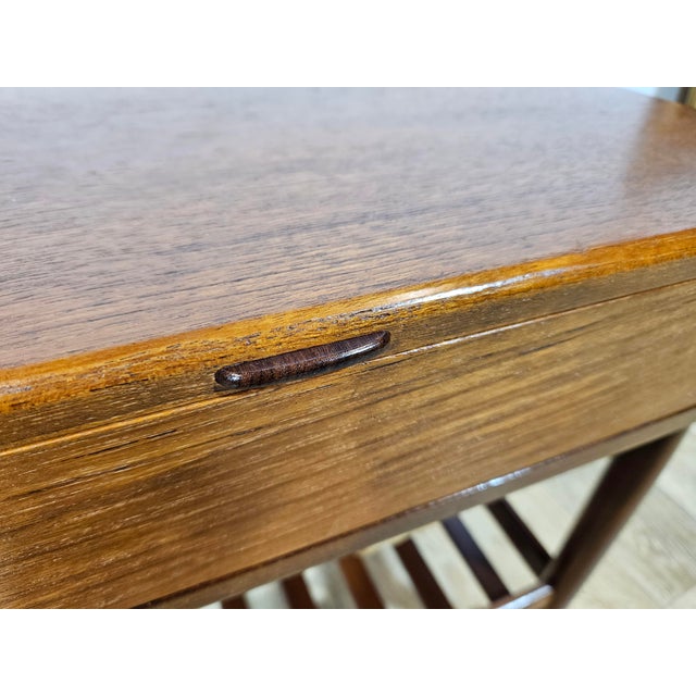 Mid-20th century teak sewing cabinet, sewing table, designed by Ejvind A. Johansson for Vitze, Denmark. This two-color...