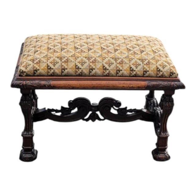 Beautiful 19th Century French carved walnut bench featuring rich hand-carved details and a newly upholstered seat in a...