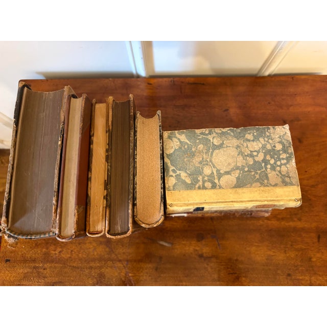 Group of 12 Assorted Leather or Marbled Bound Books, 19th Century. Books are for decorative purposes and they are from...