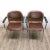 Two model SM 400 K vintage armchairs made of plastic and skai leather, standing on chromed steel tubular feet, and...