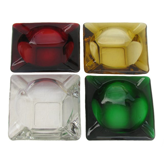 Set of four large, sculptural MCM art glass ashtrays. Their strong geometric styling offers great graphic appeal. and the...