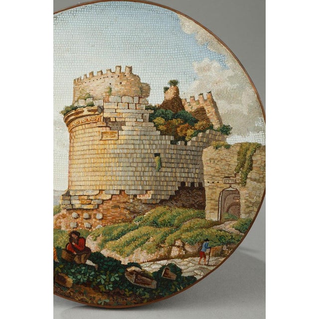 A large circular micromosaic panel representing the so called "Tomb of Cecilia Metella on the Appian way" near Rome. This...