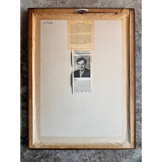 A striking mid-century folk art print by Antoine Serneels, depicting a serene female figure holding a bowl of vivid red...