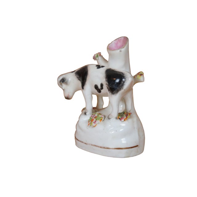 Antique 19th century Staffordshire porcelain cow bud vase / spill vase flatback figurine featuring a cow grazing in the...