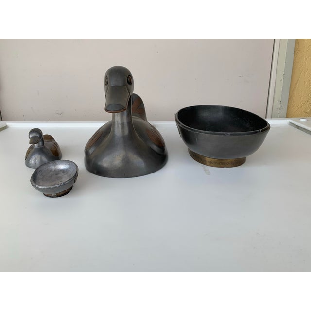 Vintage pair of pewter and brass duck trinket boxes crafted in Hong Kong during the 1960s. The body is constructed from...