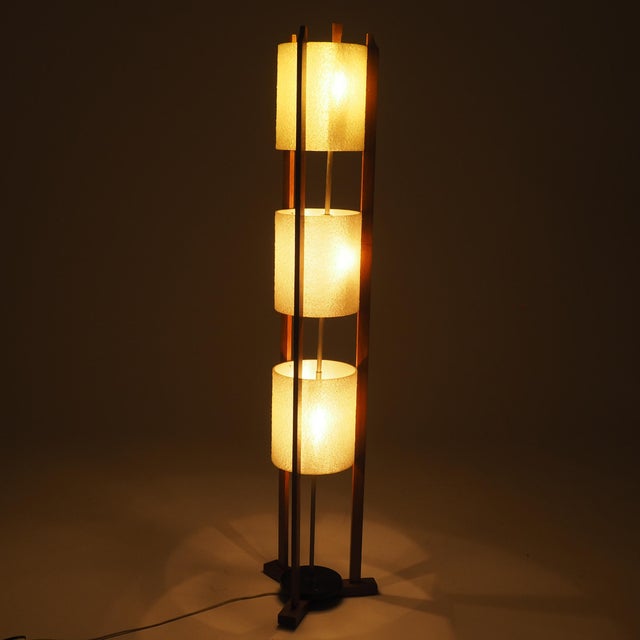 Timeless Mid-Century warmth with this striking 1950s architectural floor lamp. Crafted with an open-frame warm teak...