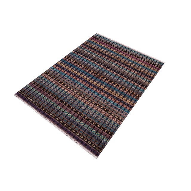 Elevate your interior with this hand-knotted high-low wool area rug, designed to bring depth and dimension to any room....