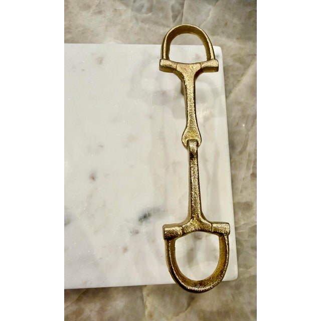 Gorgeous brass Horsebit in the style of Gucci handled Carrara marble Charcuterie board. No maker’s marks.