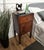 Very elegant and refined Italian 1950s Mid-Century Modern pair of bedside tables with black glass top, one drawer, central...